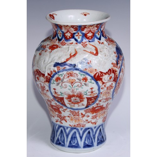 756 - A Japanese ovoid vase, moulded with dragons and painted in the Imari palette, 30cm high, Meiji perio... 