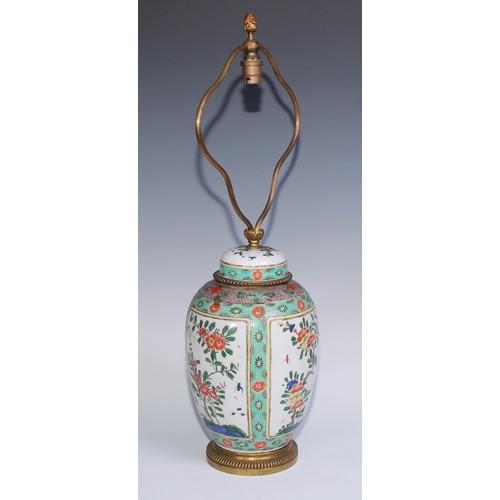 744 - A Chinese famille verte ovoid vase and cover, painted with flowering branches within rectangular res... 