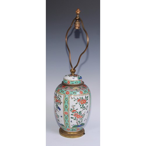 744 - A Chinese famille verte ovoid vase and cover, painted with flowering branches within rectangular res... 