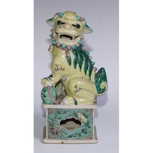 782 - A pair of Chinese porcelain models of temple dogs, decorated in tones of yellow, green and manganese... 