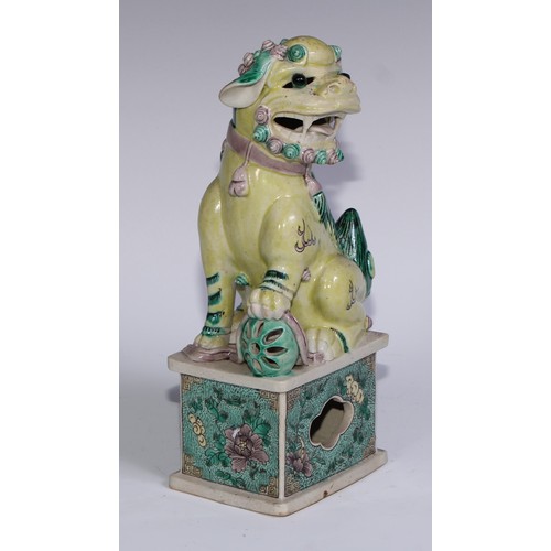 782 - A pair of Chinese porcelain models of temple dogs, decorated in tones of yellow, green and manganese... 