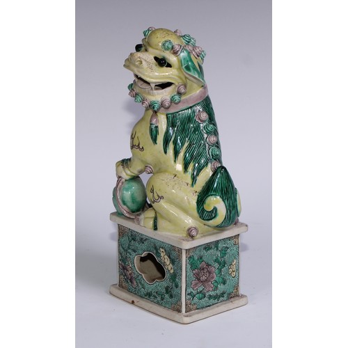 782 - A pair of Chinese porcelain models of temple dogs, decorated in tones of yellow, green and manganese... 