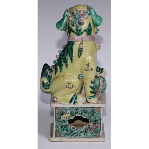 782 - A pair of Chinese porcelain models of temple dogs, decorated in tones of yellow, green and manganese... 