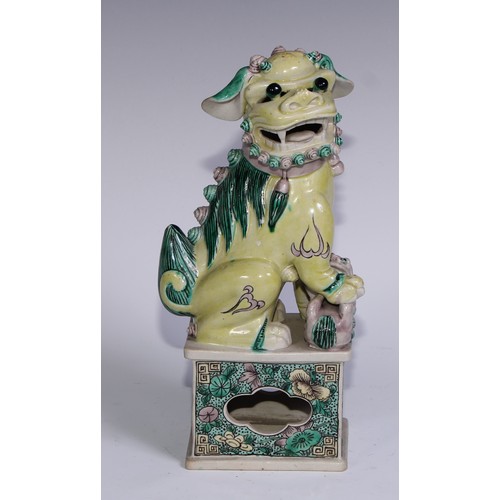 782 - A pair of Chinese porcelain models of temple dogs, decorated in tones of yellow, green and manganese... 