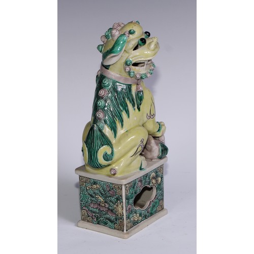 782 - A pair of Chinese porcelain models of temple dogs, decorated in tones of yellow, green and manganese... 