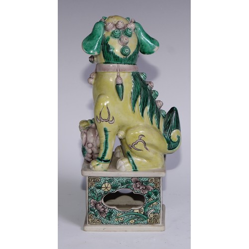 782 - A pair of Chinese porcelain models of temple dogs, decorated in tones of yellow, green and manganese... 