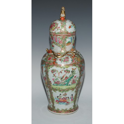 777 - A pair of Cantonese baluster vases and covers, painted in the famille rose palette with figures, bir... 