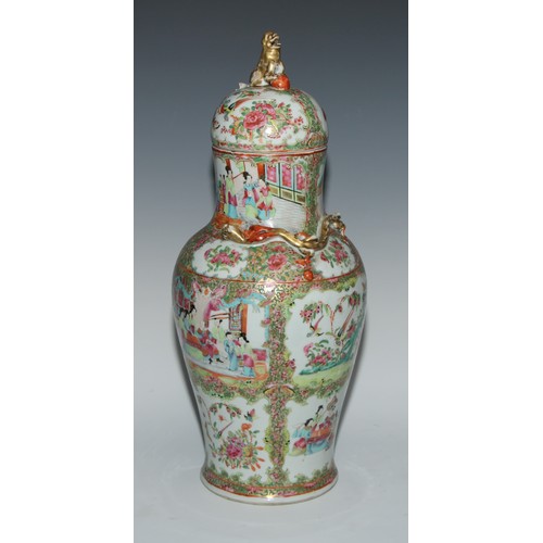 777 - A pair of Cantonese baluster vases and covers, painted in the famille rose palette with figures, bir... 