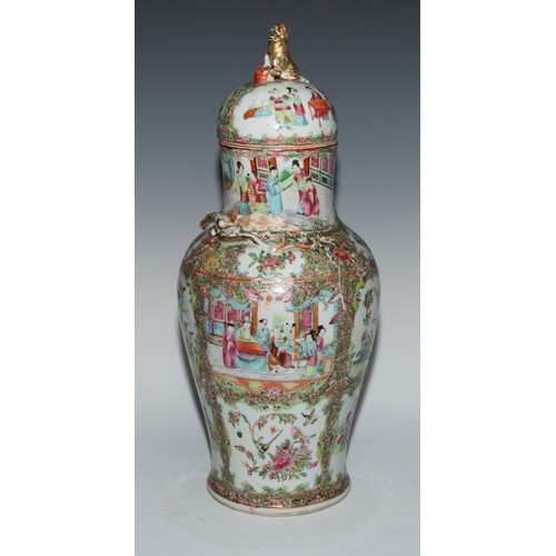 777 - A pair of Cantonese baluster vases and covers, painted in the famille rose palette with figures, bir... 