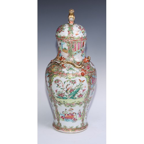 777 - A pair of Cantonese baluster vases and covers, painted in the famille rose palette with figures, bir... 