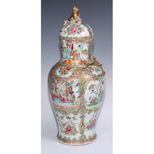 777 - A pair of Cantonese baluster vases and covers, painted in the famille rose palette with figures, bir... 