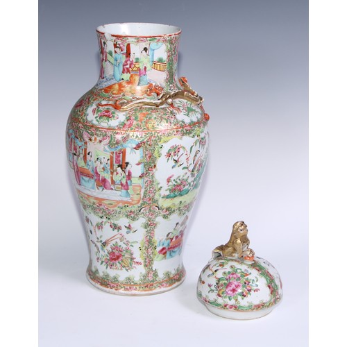 777 - A pair of Cantonese baluster vases and covers, painted in the famille rose palette with figures, bir... 