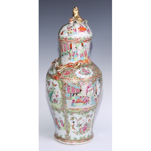 777 - A pair of Cantonese baluster vases and covers, painted in the famille rose palette with figures, bir... 