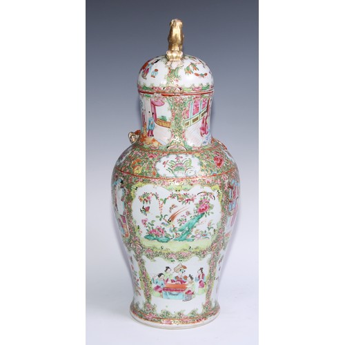 777 - A pair of Cantonese baluster vases and covers, painted in the famille rose palette with figures, bir... 