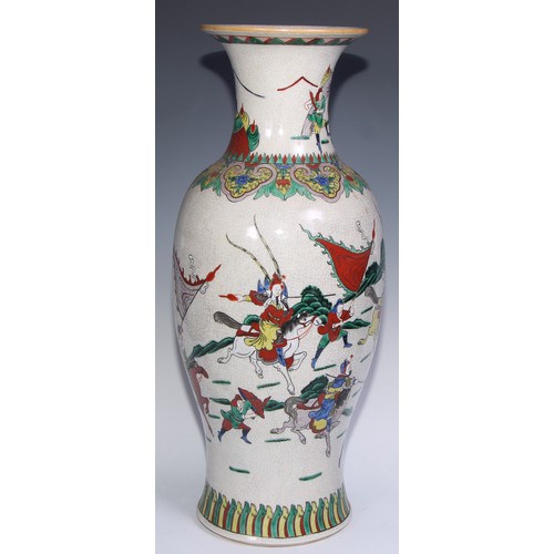 772 - A large Chinese crackle glaze ovoid vase, painted in polychrome with a battle scene, lappet border t... 