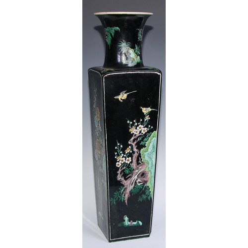 773 - A large Chinese famille noir tapered slab-sided vase, painted in polychrome enamels with panels of b... 