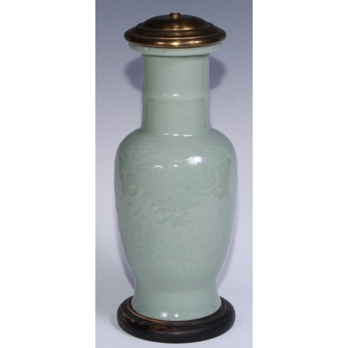 741 - A Chinese celadon ovoid vase, moulded in shallow relief with scrolls, 31.5cm high, later mounted as ... 