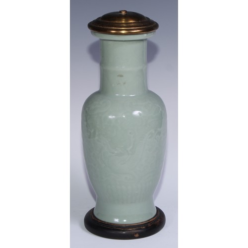 741 - A Chinese celadon ovoid vase, moulded in shallow relief with scrolls, 31.5cm high, later mounted as ... 