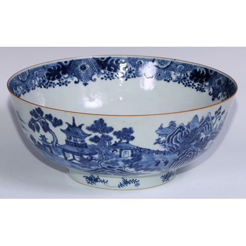 770 - A large 18th century Chinese punch bowl, decorated in tones of underglaze blue with figures on a bri... 