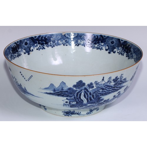 770 - A large 18th century Chinese punch bowl, decorated in tones of underglaze blue with figures on a bri... 