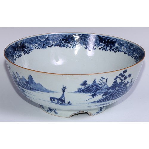 770 - A large 18th century Chinese punch bowl, decorated in tones of underglaze blue with figures on a bri... 