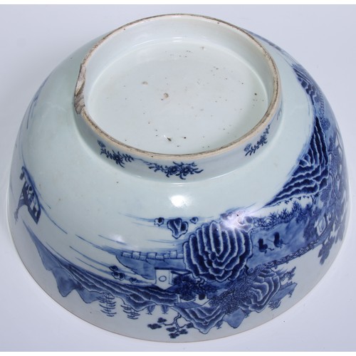 770 - A large 18th century Chinese punch bowl, decorated in tones of underglaze blue with figures on a bri... 