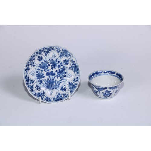 784 - A pair of Chinese wine cups or tea bowls and saucers, painted in tones of underglaze blue with flowe... 