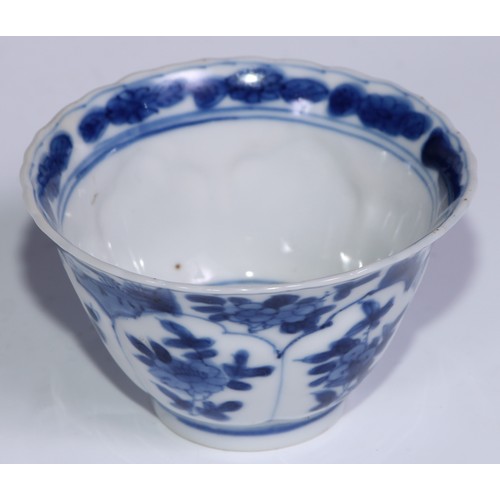 784 - A pair of Chinese wine cups or tea bowls and saucers, painted in tones of underglaze blue with flowe... 