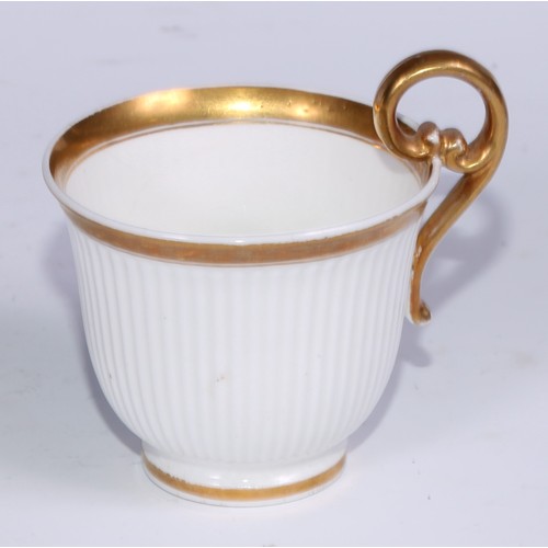 467 - A Swansea trio, comprising teacup, coffee cup and stand, each fluted and outlined in gilt, the sauce... 