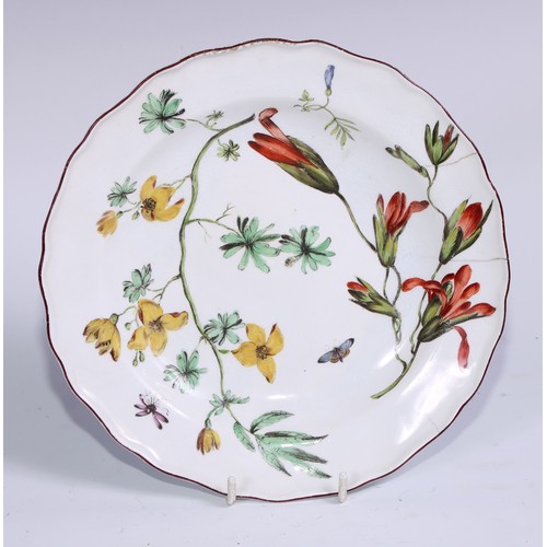 400 - A Chelsea shaped circular dish, painted in polychrome enamels with botanical specimens and a butterf... 