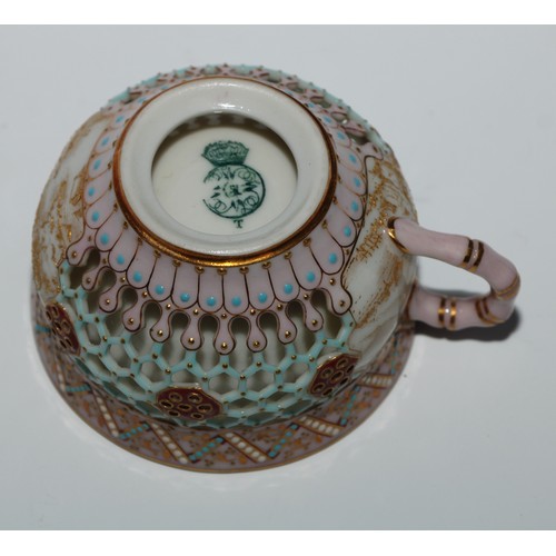 428 - A Royal Worcester reticulated cup and saucer, in the manner of George Owen, decorated in the Japanes... 