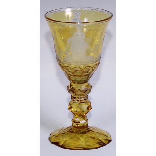 537 - A Bohemian amber-flashed glass goblet, wheel engraved with figures emblematic of the seasons, above ... 