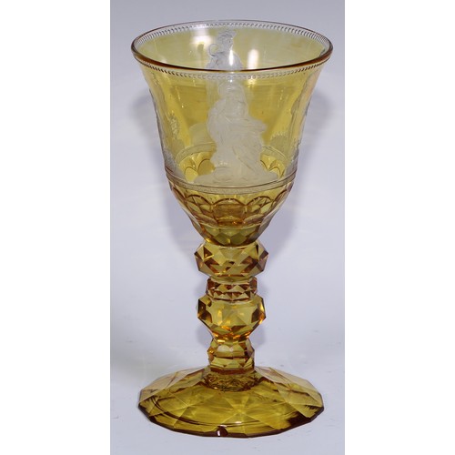 537 - A Bohemian amber-flashed glass goblet, wheel engraved with figures emblematic of the seasons, above ... 