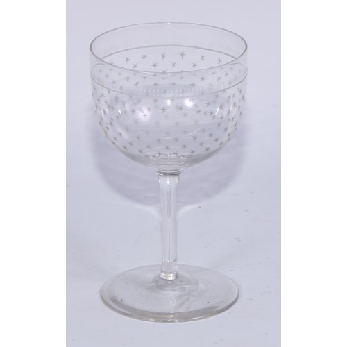 550 - A set of twelve early 20th century wine glasses, acid etched with stars, 12cm high, c.1910; a set of... 