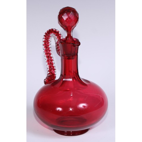 548 - A pair of Victorian cranberry glass compressed ovoid claret jugs, prismatic stoppers, rope-twist han... 