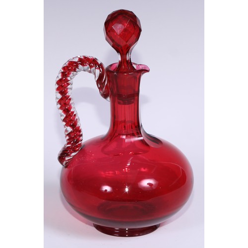 548 - A pair of Victorian cranberry glass compressed ovoid claret jugs, prismatic stoppers, rope-twist han... 