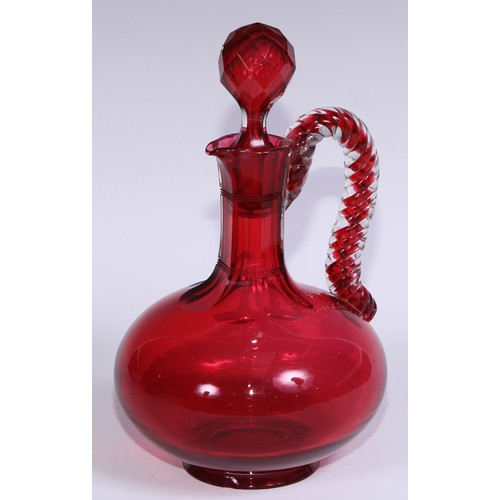 548 - A pair of Victorian cranberry glass compressed ovoid claret jugs, prismatic stoppers, rope-twist han... 