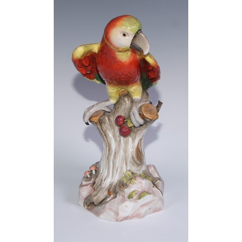 530 - A pair of German porcelain models of parrots, in the manner of Meissen, brightly painted and perched... 