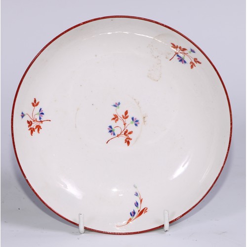 485 - A Pinxton tea cup and saucer, Pattern no.1, red sprig version, the saucer 14.5cm diam, c.1796 - 99