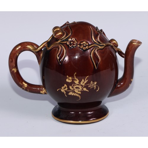 443 - A Brameld cadogan teapot, moulded and picked out in gilt with flowers and buds on a brown glazed gro... 