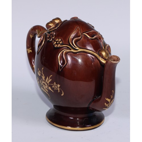 443 - A Brameld cadogan teapot, moulded and picked out in gilt with flowers and buds on a brown glazed gro... 