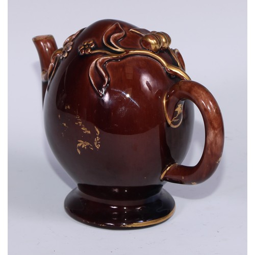 443 - A Brameld cadogan teapot, moulded and picked out in gilt with flowers and buds on a brown glazed gro... 