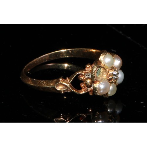 360 - A Victorian gold flower head mourning ring, set with a central old cut diamond surrounded by five se... 