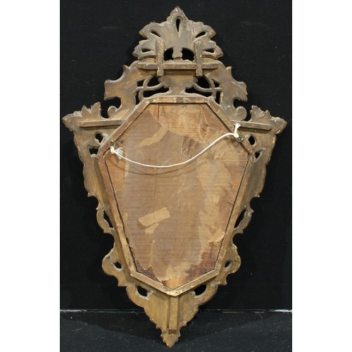 1312 - A Baroque giltwood cartouche shaped looking glass, pierced and carved with flowers and leafy scrolls... 