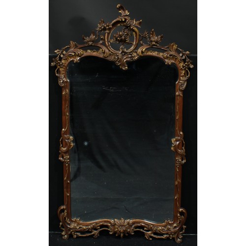 1356 - A parcel-gilt walnut chimney glass, plain mirror plate, the frame carved and applied with scrolling ... 