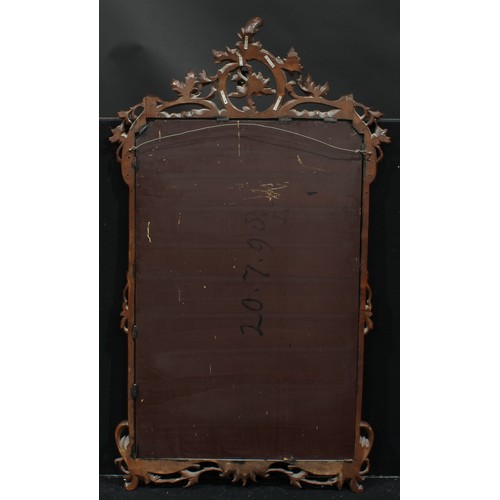 1356 - A parcel-gilt walnut chimney glass, plain mirror plate, the frame carved and applied with scrolling ... 