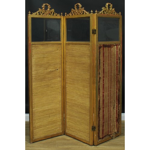 1353 - A Louis XVI Revival giltwood and gesso three-fold screen, each bevelled quarter-glazed panel crested... 