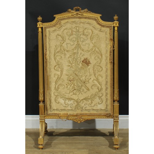 1354 - A Louis XVI Revival giltwood fire screen, arched cresting carved with a quiver of arrows crossed wit... 