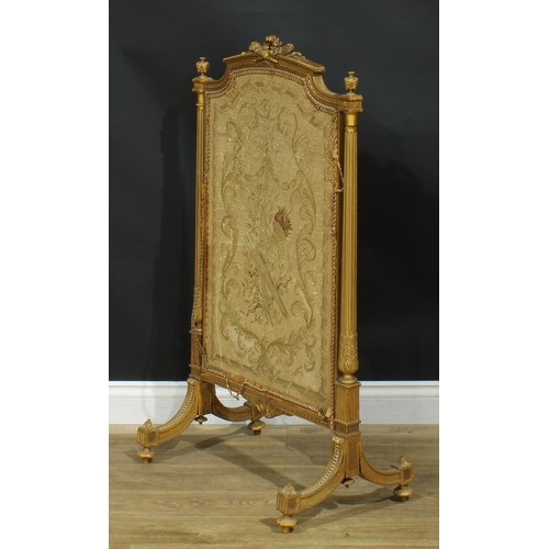 1354 - A Louis XVI Revival giltwood fire screen, arched cresting carved with a quiver of arrows crossed wit... 