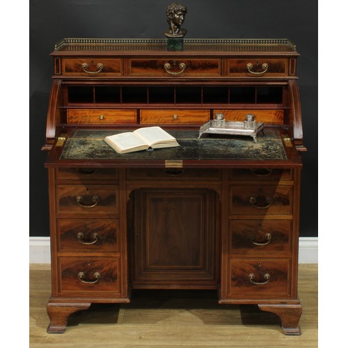 1334 - A late Victorian mahogany barrel-top kneehole desk, by Cooper & Holt (fl.1862-1889), badged, brass t... 